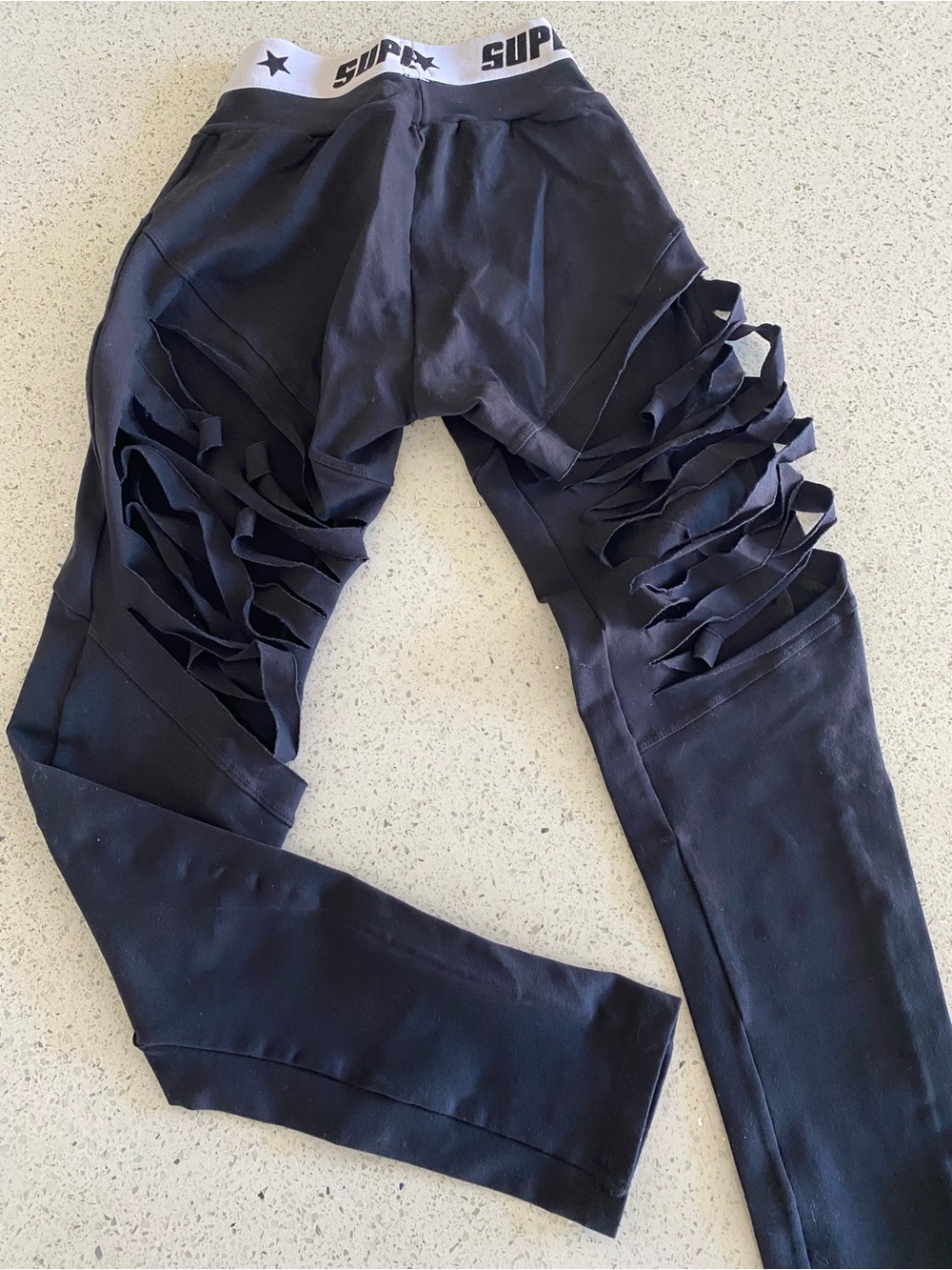 SUPERHOT Black Ruffle Cutout Leggings with Branded Elastic Waistband